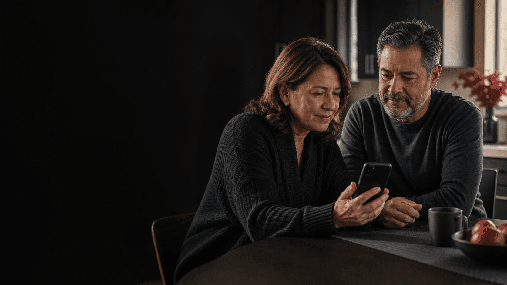 A couple naturally reviewing a disease research update together on a phone